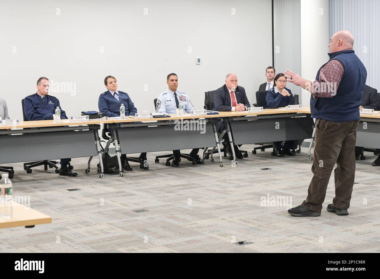 Matthew Correa, special assistant to U.S. Army Brig. Gen. David Trybula, U.S. Army Natick Soldier Systems Center, Mass., speaks to Lt. Gen. Shaun Q. Morris, seated left, Air Force Life Cycle Management Center commander, during a meeting at the University of Massachusetts Lowell Research Institute’s Northstar campus in Lincoln, Mass, Jan. 23. Correa’s remarks focused on the NEXUS Center at the Northstar campus, which is designed to bring together a broad range of acquisition and innovation representatives from across the Department of Defense. Stock Photo