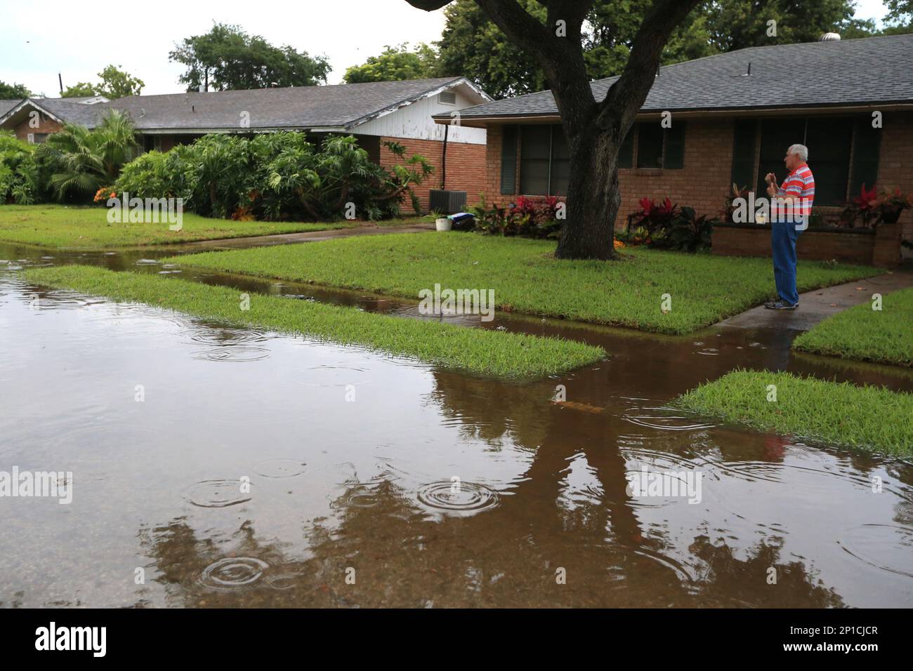 Ed Carter checks out the water around his house on Tripoli Drive on Monday, May 16, 2016 in
