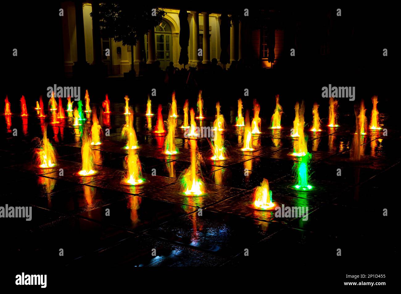 Colorful fountain on a street at night Stock Photo - Alamy