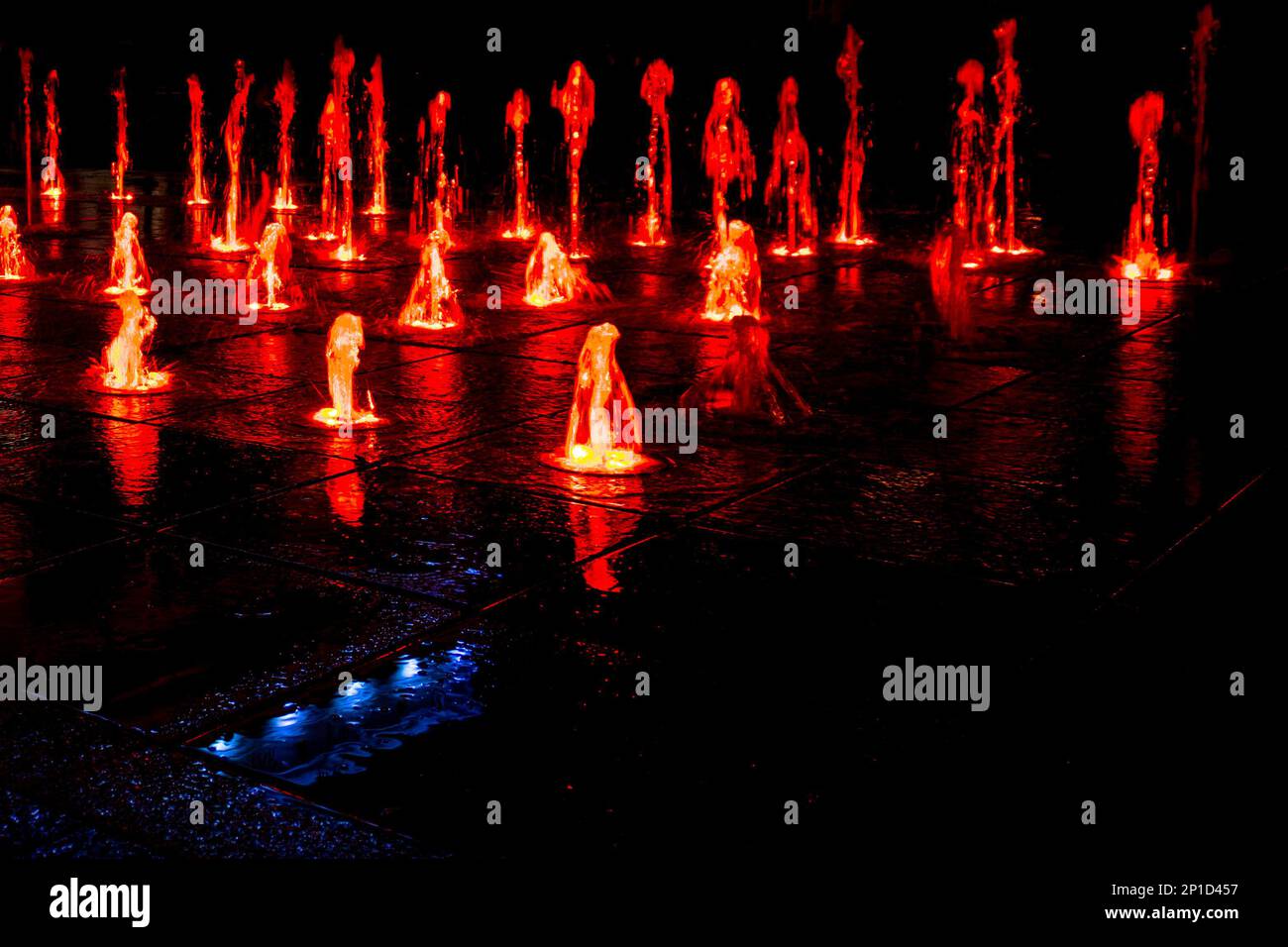 Colorful fountain on a street at night Stock Photo - Alamy