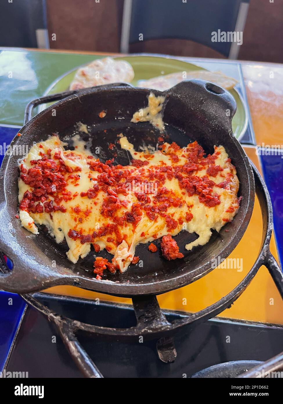 Baked Oaxaca Cheese and Chorizo dip in a castiron pan Stock Photo Alamy