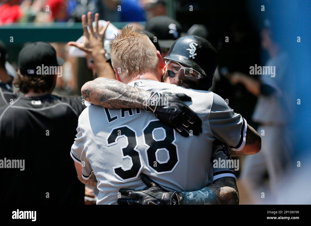 Chicago White Sox starting pitcher Mat Latos and Brett Lawrie (38)  celebrate in the dugout after Lawrie's two-run home run off of Texas  Rangers' Cole Hamels in the fourth inning of a