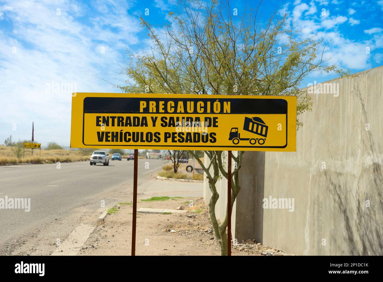 Caution entry and exit of heavy vehicles sign in Spanish, seen in