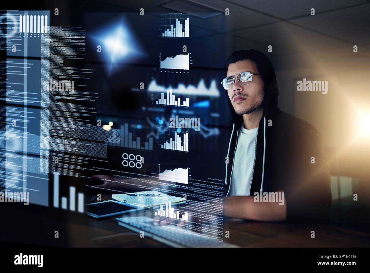 He can hack through any security measure. Shot of a young hacker cracking a computer code in the dark. Stock Photo
