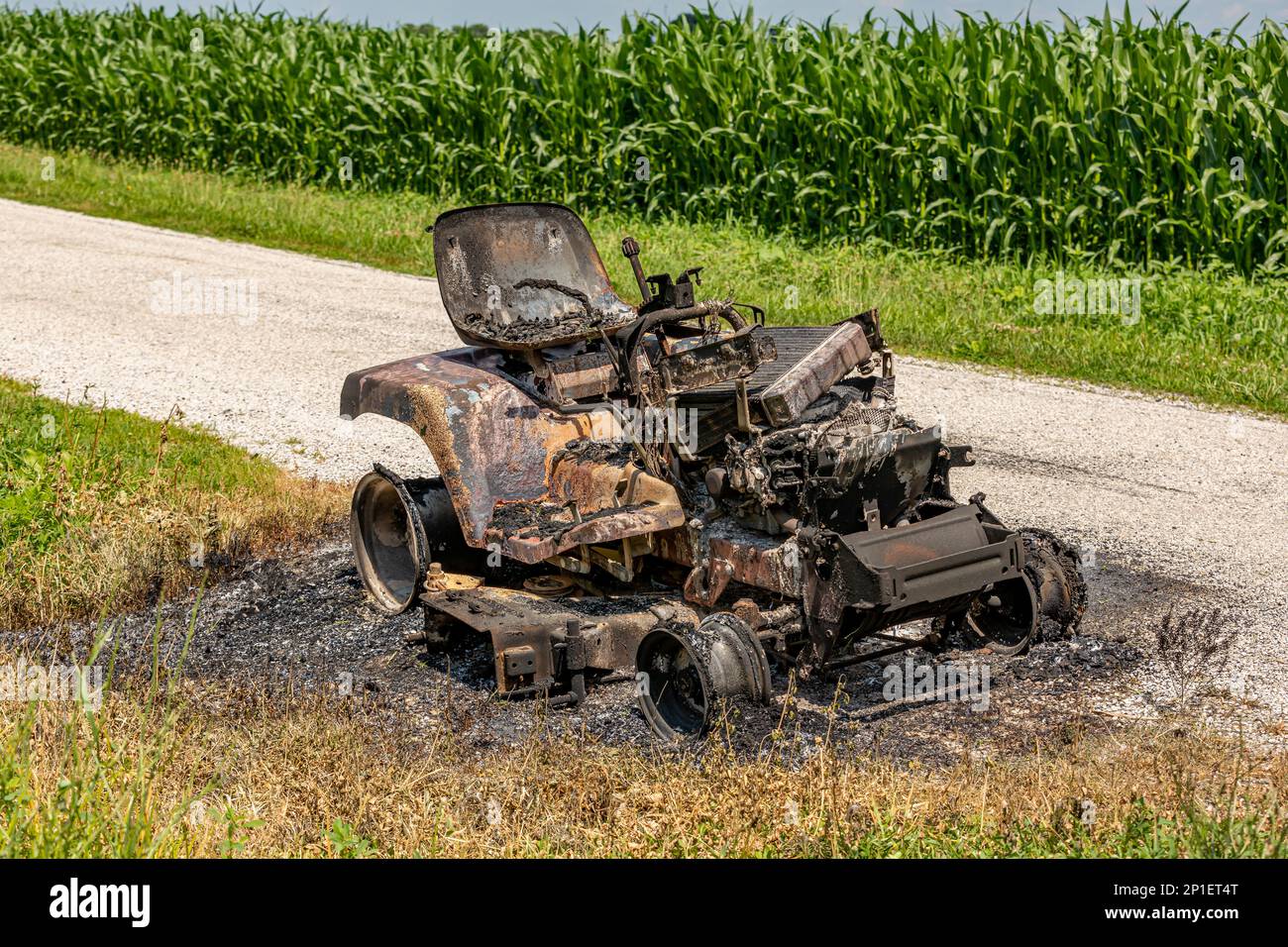 Lawn mower tractor damaged from fire. Lawn equipment maintenance, repair and homeowners insurance concept. Stock Photo