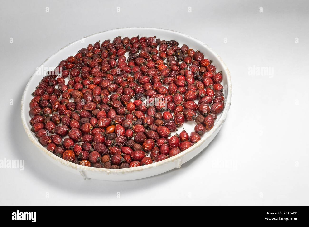 dried rose hips on a plate Stock Photo Alamy