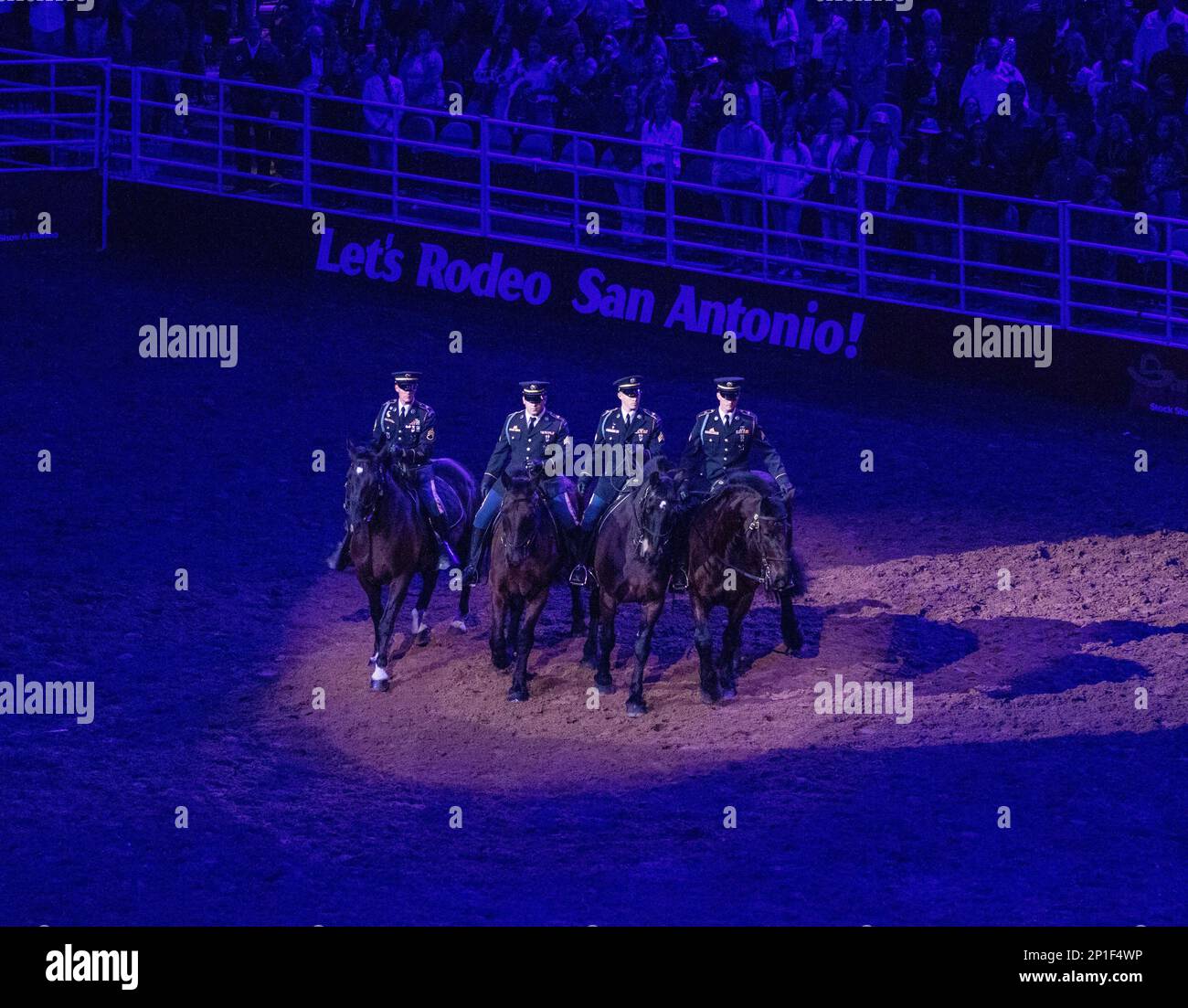 U.S. Army North Caisson Platoon members ride horses in formation during Military Appreciation Night at the San Antonio Stock Show and Rodeo in San Antonio, Texas, Feb. 18, 2023. The San Antonio Stock Show and Rodeo is one of the largest events held each year with approximately 1.5 million visitors entering the fairgrounds each year. Stock Photo