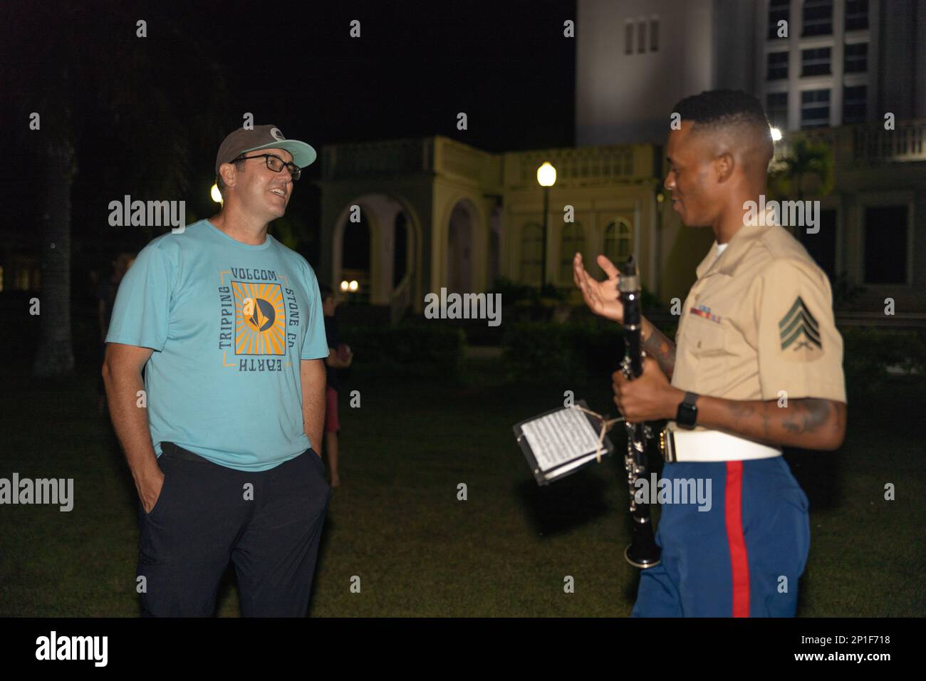 A U.S. Marine with Marine Corps Forces Pacific Band interacts with an attendee after a live concert for the local community at Plaza de Espana, Hagatna, Guam, Jan. 23, 2023. The MARFORPAC Band participated in multiple community engagements during their visit to Guam as part of the Naval Support Activity, Marine Corps Base Camp Blaz Reactivation and Naming Ceremony. In order to encourage music education and showcase the vibrant history and tradition of military music, the band is active in providing clinics and concerts for the communities they serve. The MARFORPAC Band performs throughout the Stock Photo