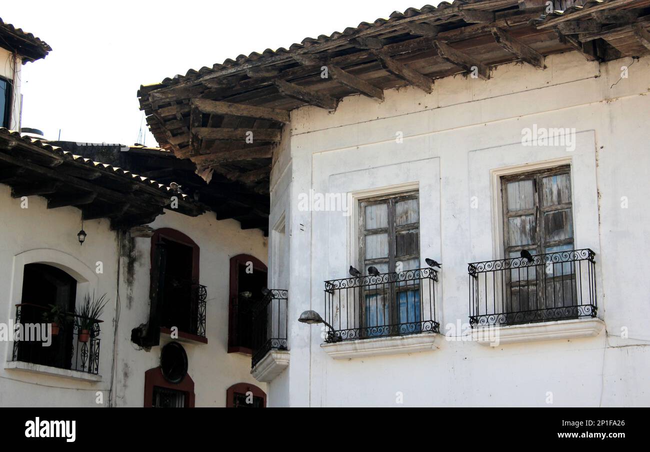 View of streets and traditional facades, houses with door, windows and tile roof in Cuetzalan Puebla Mexico Stock Photo