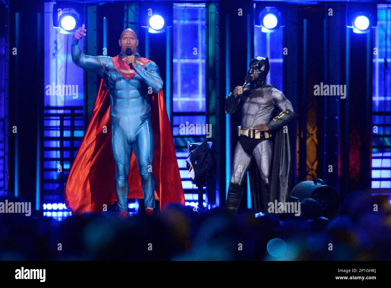 Kevin Hart, dressed as Batman, and Dwayne Johnson, dressed as Superman,  speak at the MTV Movie Awards at Warner Bros. Studio on Saturday, April 9,  2016, in Burbank, Calif. (Kevork Djansezian/Pool Photo