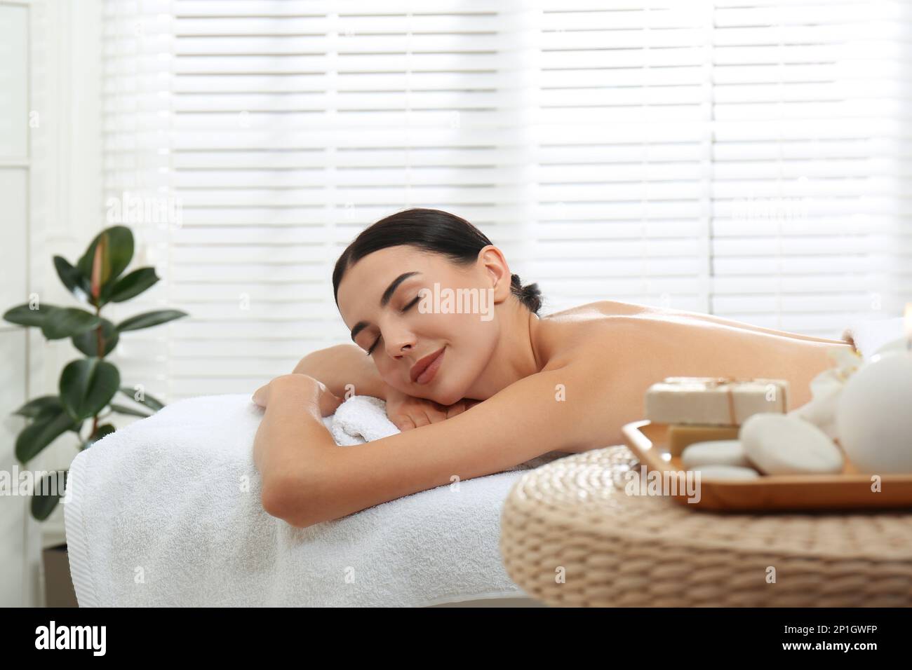 Beautiful young woman relaxing in spa salon Stock Photo - Alamy