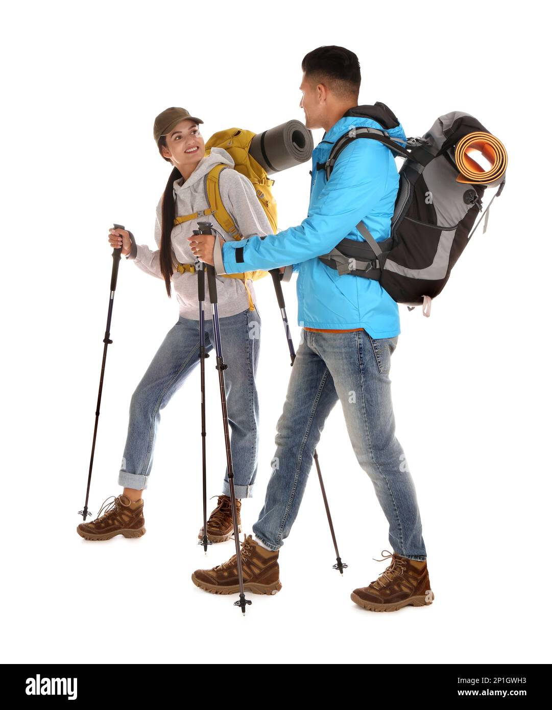 Couple of hikers with backpacks and trekking poles on white background Stock Photo