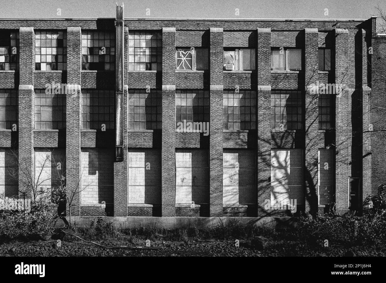 A weathered old factory standing next to the canal in Laconia, New