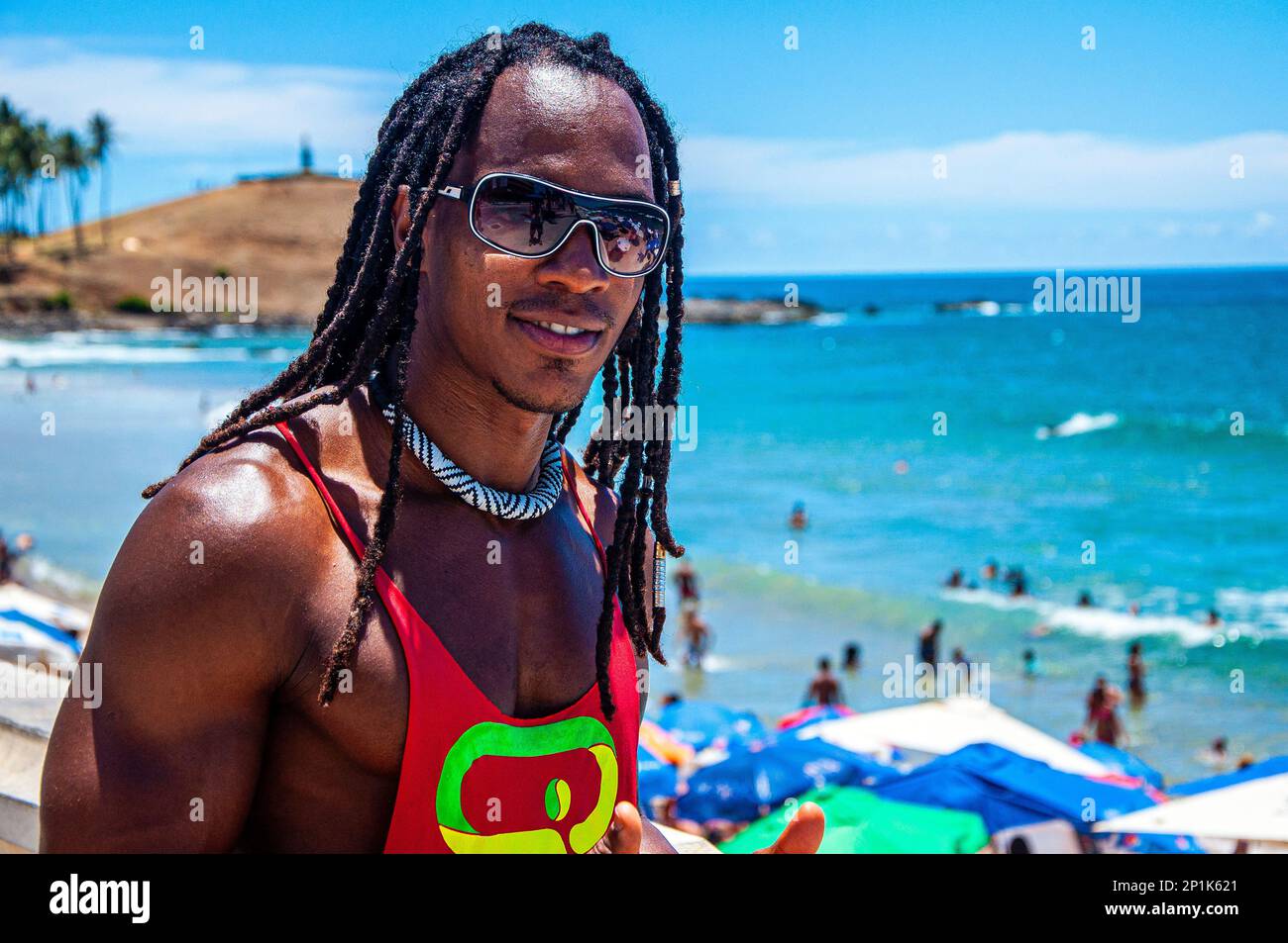 Athletic black man posing in front of the sea in Salvador de Bahia, Brazil Stock Photo