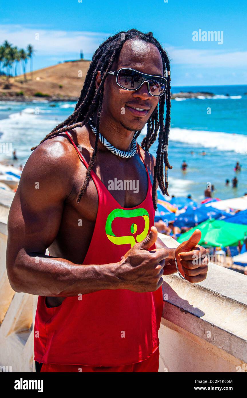 Athletic black man posing in front of the sea in Salvador de Bahia, Brazil Stock Photo