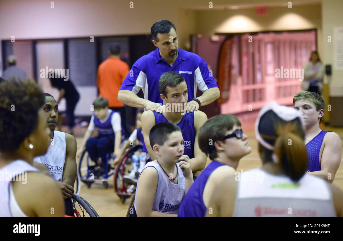 Alex Armas gives his son Samuel (16) a massage during BlazeSports Wheelchair Basketball practice at Shepherd Spinal Center on Saturday, February 20, 2016 in Atlanta, Ga. Julie and Alex Armas have three sons and two of them, Samuel (16) and Zachary (10), have spina bifida. Julie had fetal surgery during her pregnancy with Samuel in hopes of repairing the lesion on his back. USA Today covered the controversial surgery and a photographer captured what has since become the famous "Hand of Hope" photo, which captured Samuel's hand (at 21 weeks gestation) wrapped around the surgeon's finger. Since t Stock Photo