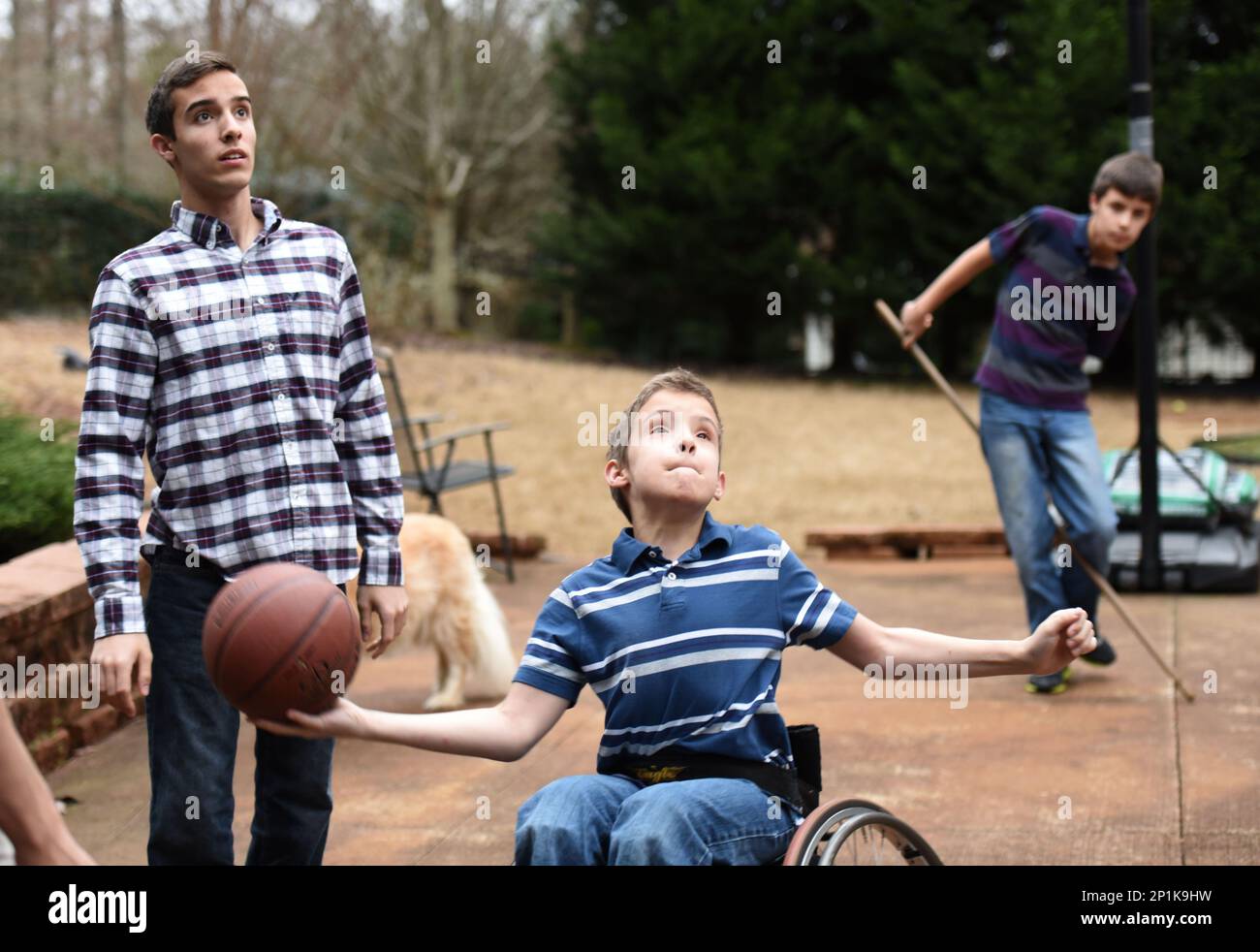 Zachary (10) gets off a shot as his brothers Samuel (16) and and Ethan (12) look at their home on Tuesday, February 16, 2016 in Villa Rica, Ga. Julie and Alex Armas have three sons and two of them, Samuel (16) and Zachary (10), have spina bifida. Julie had fetal surgery during her pregnancy with Samuel in hopes of repairing the lesion on his back. USA Today covered the controversial surgery and a photographer captured what has since become the famous "Hand of Hope", which captured Samuel's hand (at 21 weeks gestation) wrapped around the surgeon's finger. Since then, the Armas family has experi Stock Photo