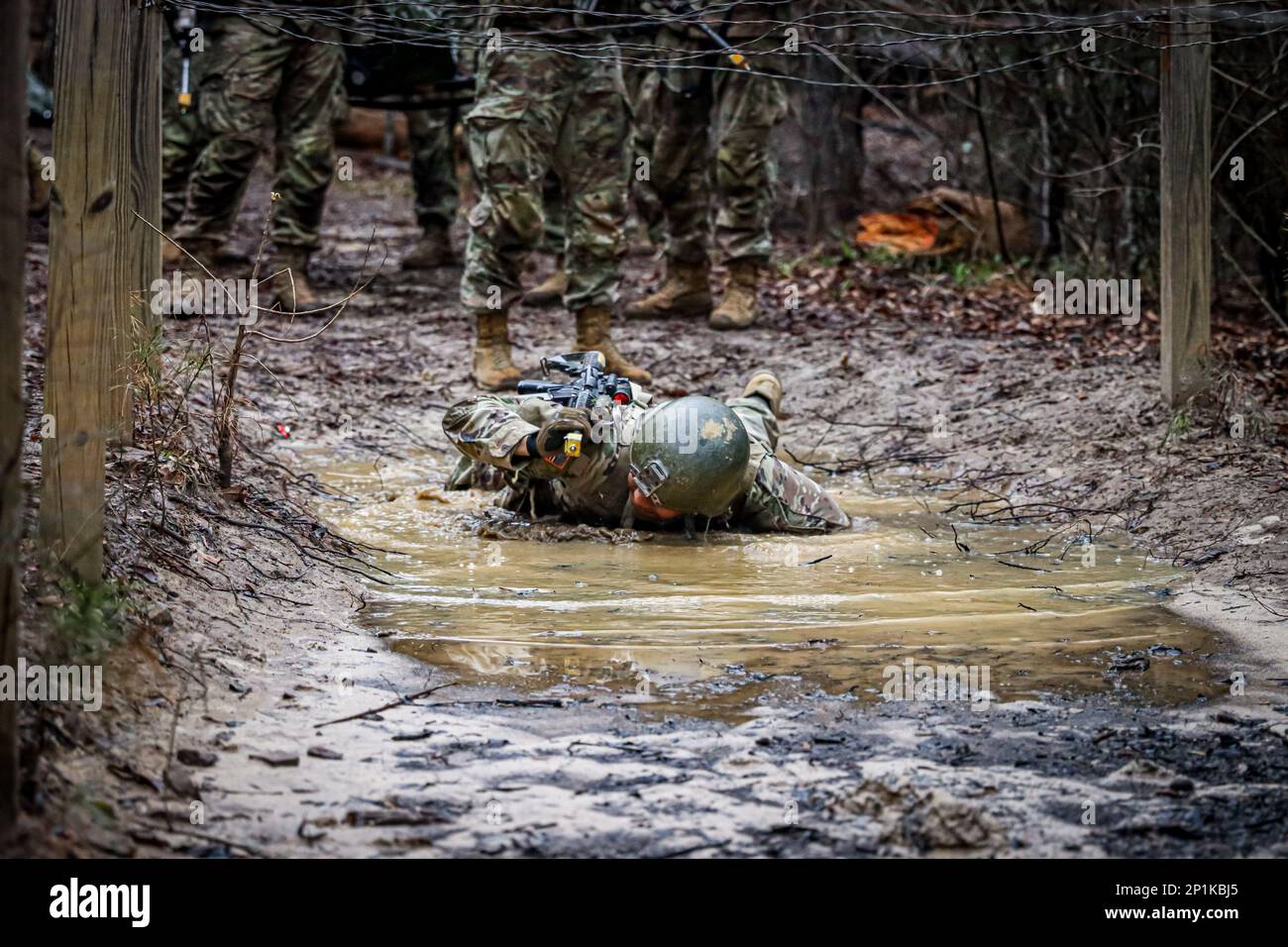 Infantry OSUT trainees with Alpha Company, 2nd battalion, 58th Infantry Regiment, 198th Infantry Brigade, navigate an obstacle during a combat lifesaver course lane at Fort Benning, GA, February 11, 2023. Stock Photo