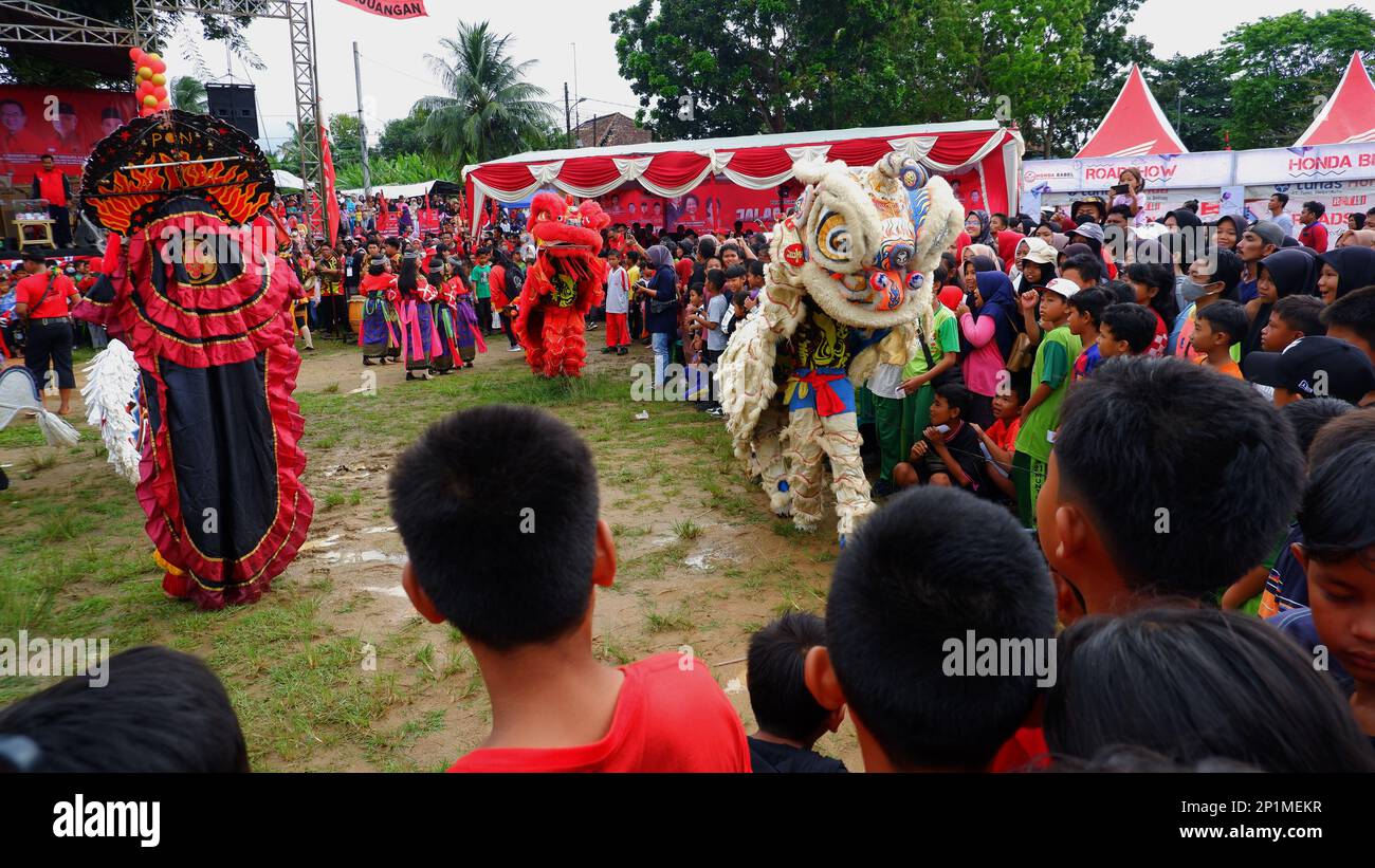 Barongsai Art Performances, Seen By Crowds Of Residents, In The City Of Muntok During The Day In Muntok Stock Photo