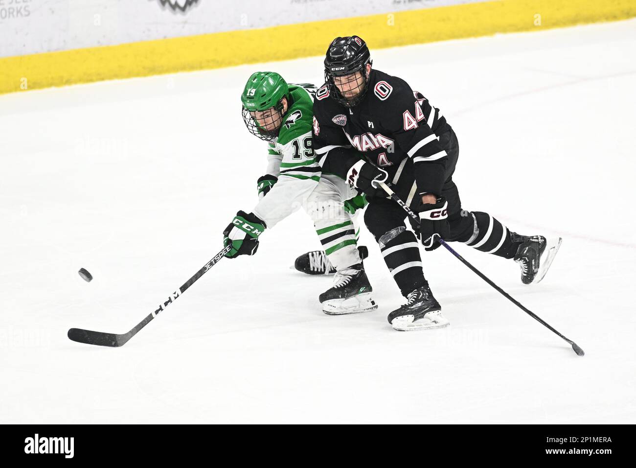 North Dakota Fighting Hawks forward Mark Senden (19) attempts to skate  around Omaha Mavericks forward Jake Pivonka (44) during a NCAA men's hockey  game between the Omaha Mavericks and the University of