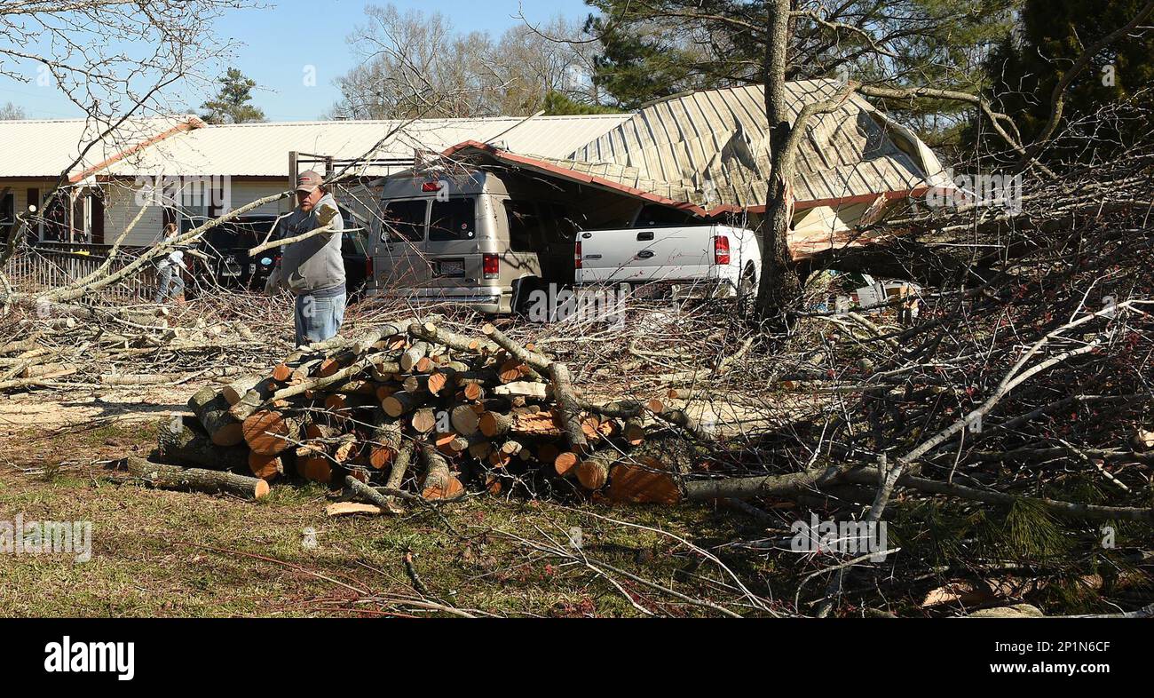 People clean up damage from storms that struck Tuesday evening in and