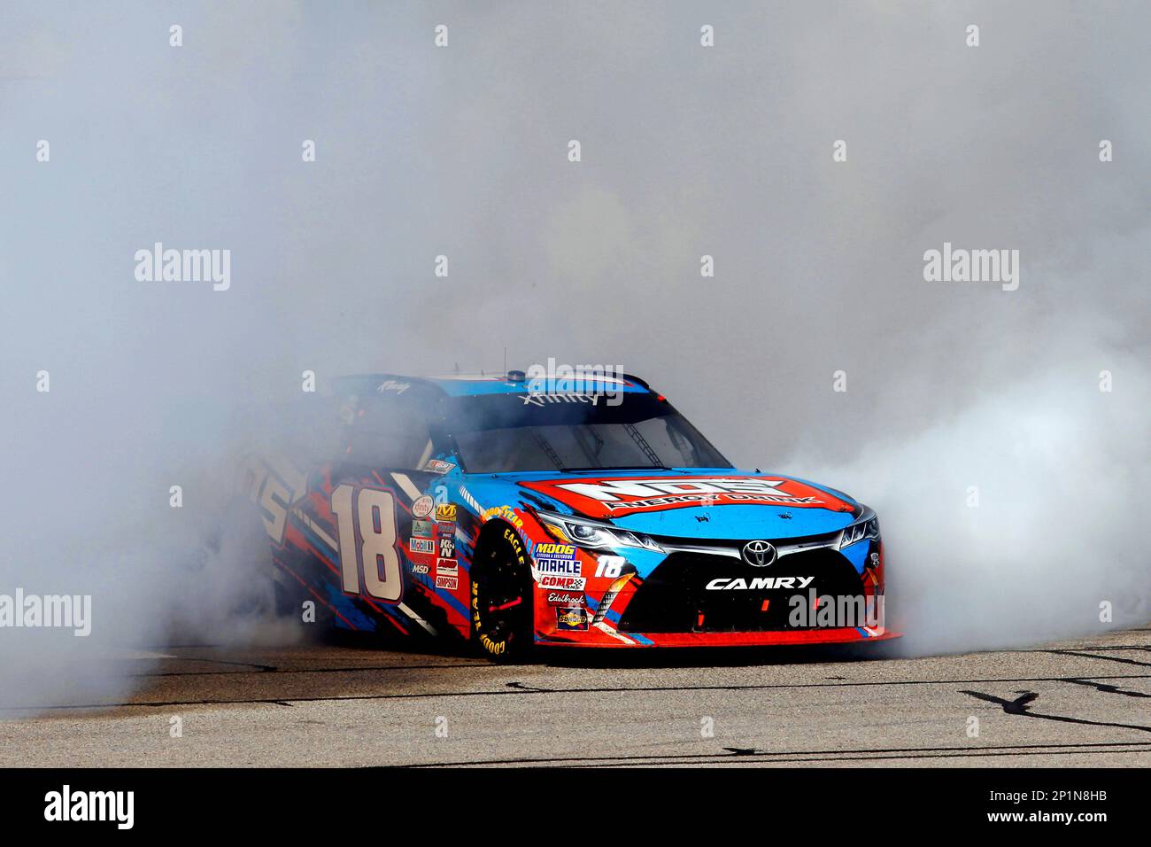 Kyle Busch, NOS Energy Drink Toyota Camry celebrates his win with a burnout at the NASCAR