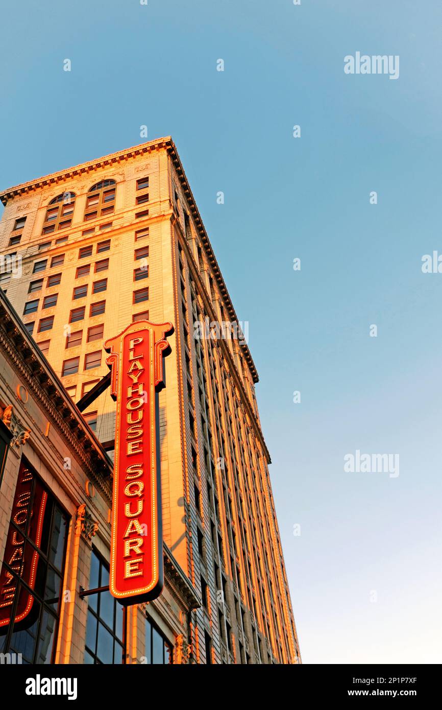 The iconic Playhouse Square sign hangs outdoors lit by the setting sun above the Playhouse Square theater district in downtown Cleveland, Ohio, USA Stock Photo