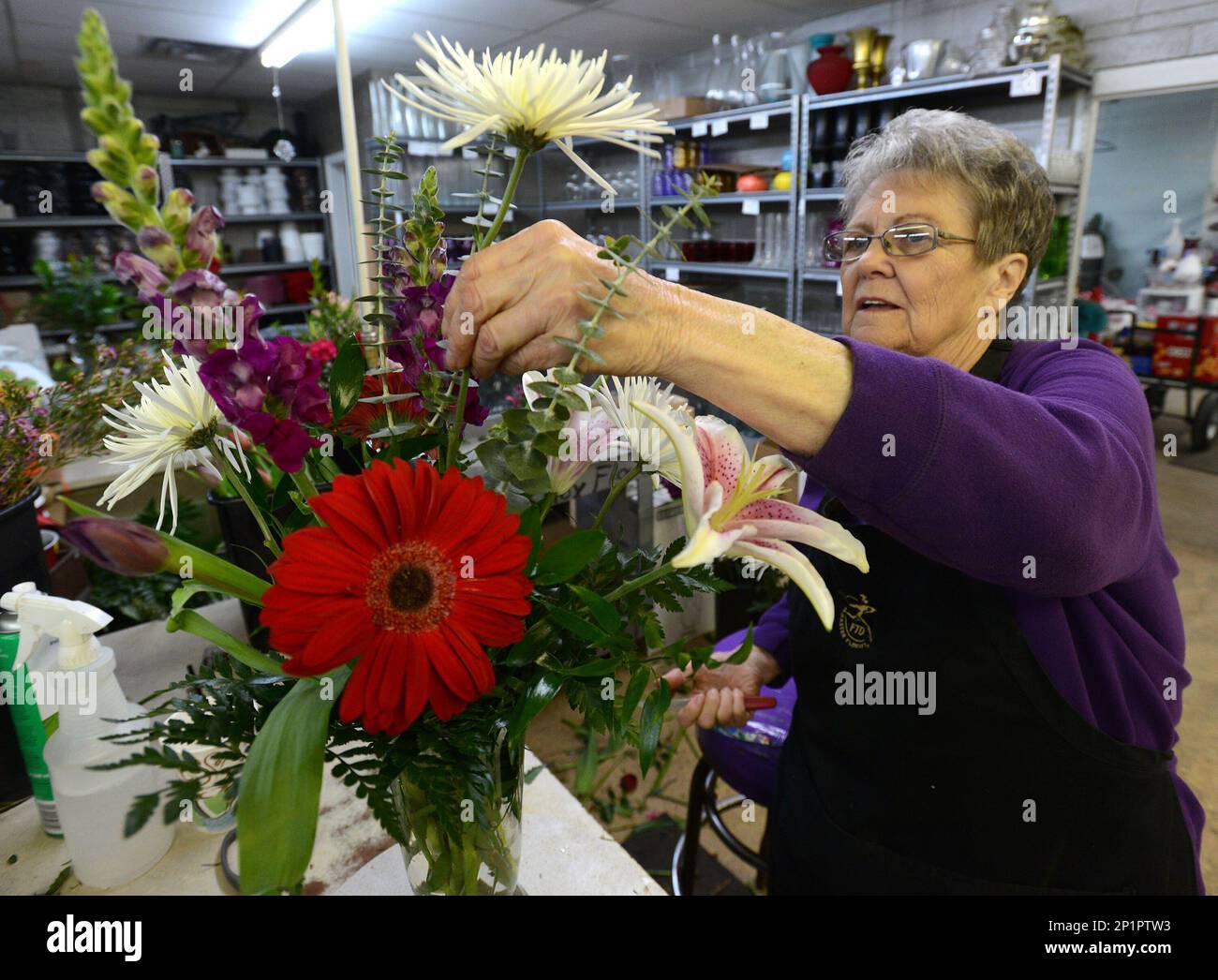 Barbara Burns arranges flowers in a vase Wednesday morning, Feb. 10, 2016 at Mark Knox Flowers