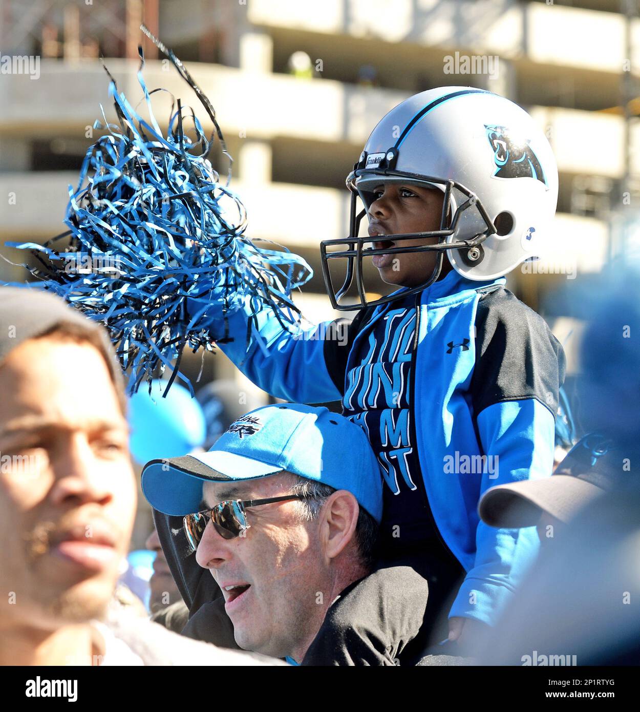 A young Carolina Panthers fan cheers at the Panthers Pride Rally