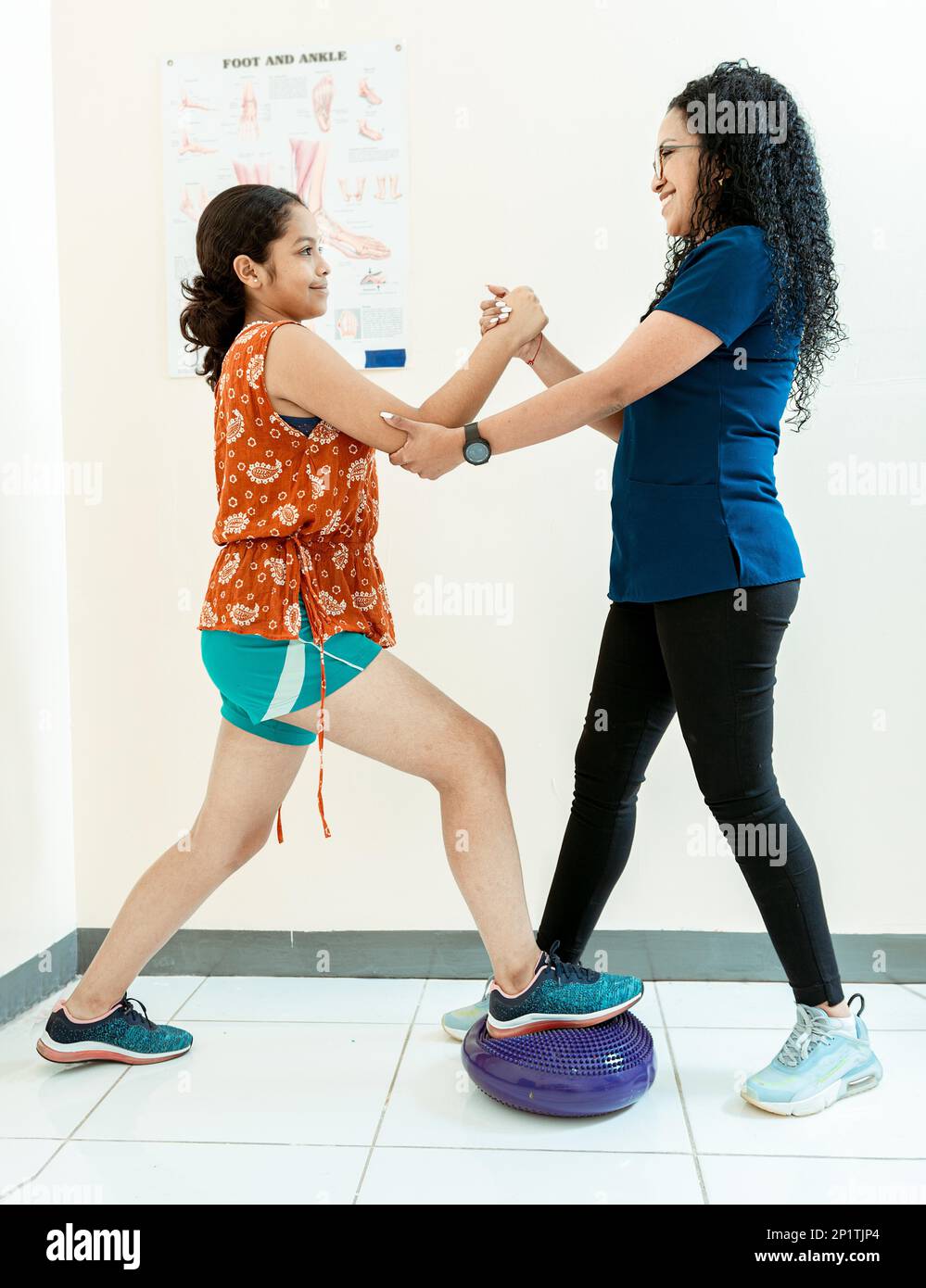 Balance physiotherapy on disc. Physiotherapist woman helping patient on
