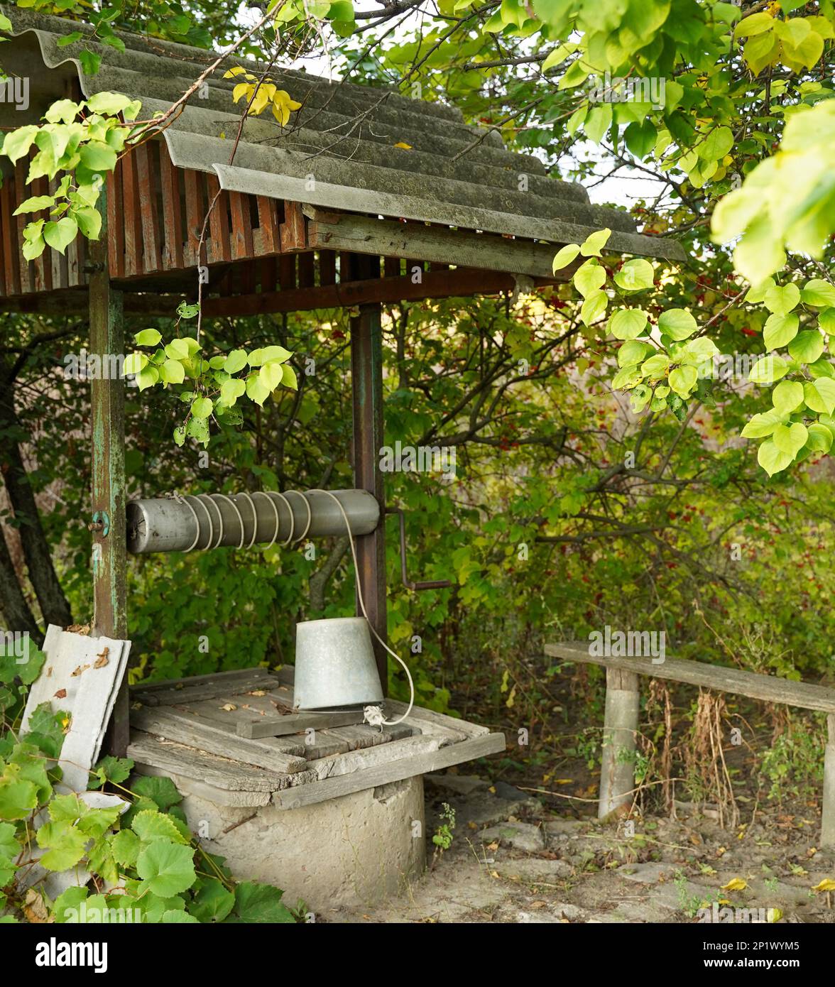 Retro wooden well water in the village. Peaceful scene Stock Photo