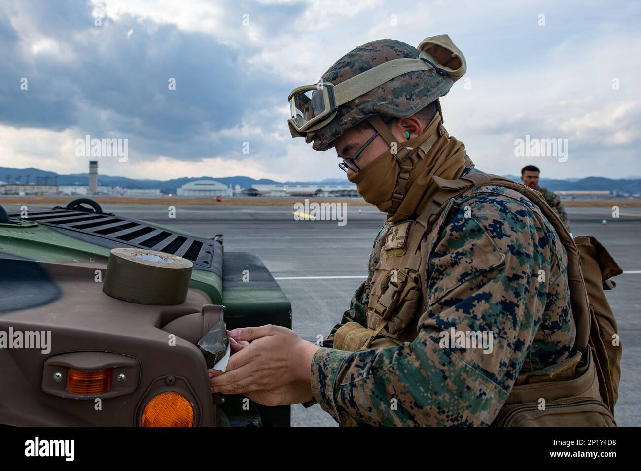 U.S. Marine Corps Lance Cpl. Tony Nguyen, a landing support specialist with Combat Logistics Battalion 31, 31st Marine Expeditionary Unit (MEU), prepares a Humvee for a helicopter support team (HST) exercise at Marine Corps Air Station Iwakuni, Japan, Feb. 19, 2023. The HST exercise was conducted to certify pilots in sling load operations and improve tactical proficiency. The 31st MEU, the Marine Corps’ only continuously forward-deployed MEU, provides a flexible and lethal force ready to perform a wide range of military operations as the premiere crisis response force in the Indo-Pacific regio Stock Photo