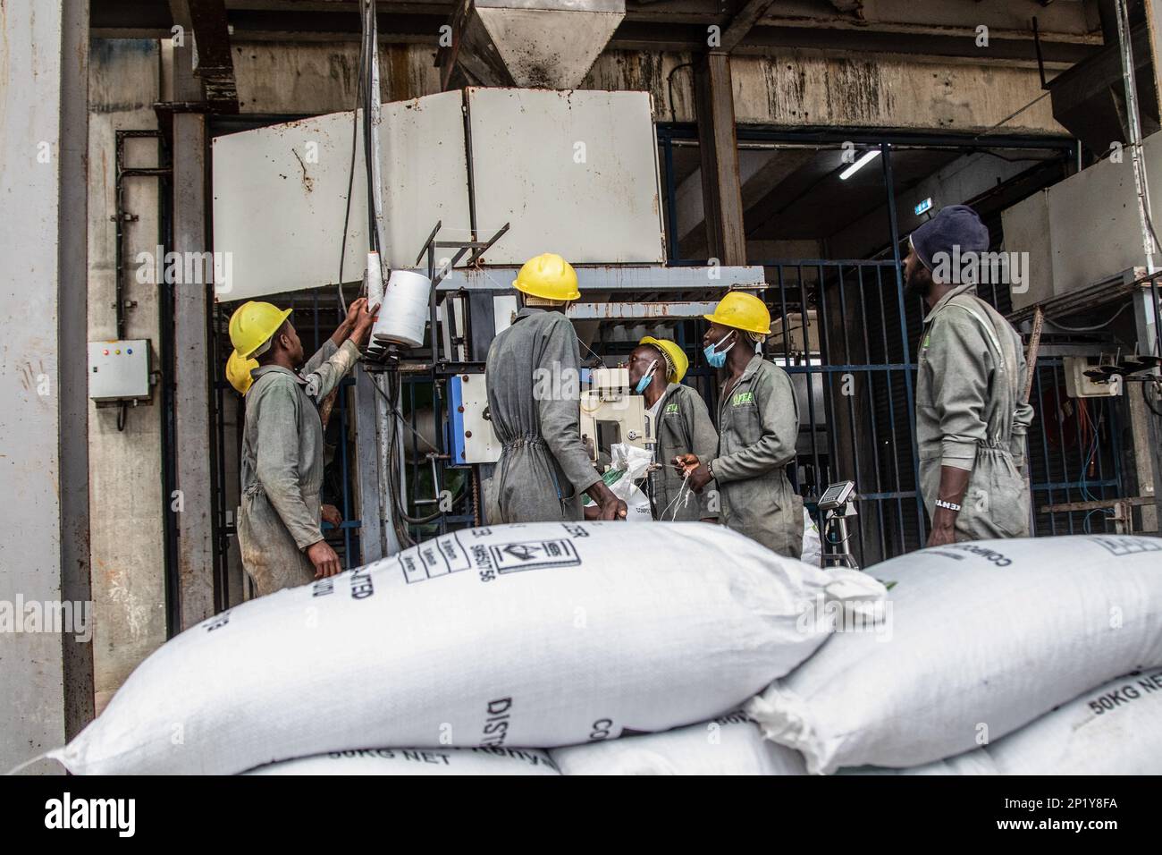 Workers operate a fertilizer packaging unit at the Fertiplant