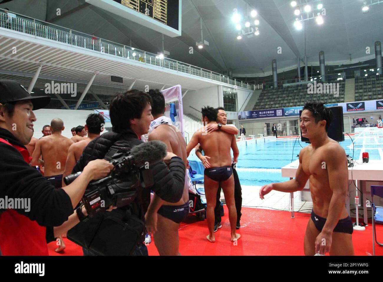 Players of Japan men's national water polo team celebrate after defeating players of Kazakhstan