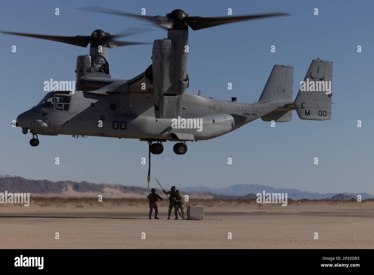 U.S. Marines with Marine Medium Tiltrotor Squadron (VMM) 261 and Combat Logistics Battalion (CLB) 7 practice external lifts with an MV-22B Osprey at Marine Corps Air Ground Combat Center Twentynine Palms, California, Jan. 25, 2023. VMM-261 trained to support Marine ground units during Service Level Training Exercise 2-23, a series of exercises designed to prepare Marines for operations around the globe. VMM-261 is a subordinate unit of 2nd Marine Aircraft Wing, the aviation combat element of II Marine Expeditionary Force. Stock Photo