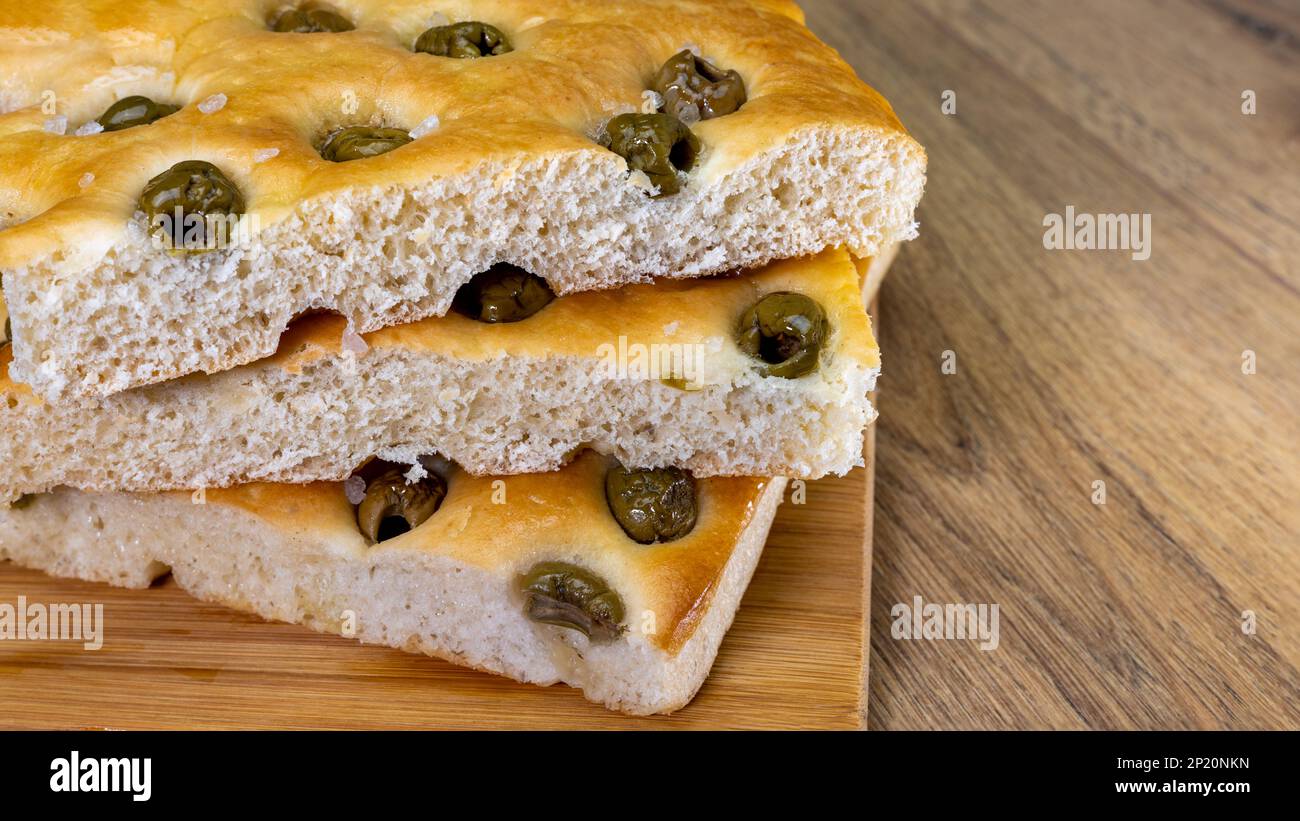 banner or stack of focaccia with olives and oil, healthy mediterranean food, copy space Stock Photo
