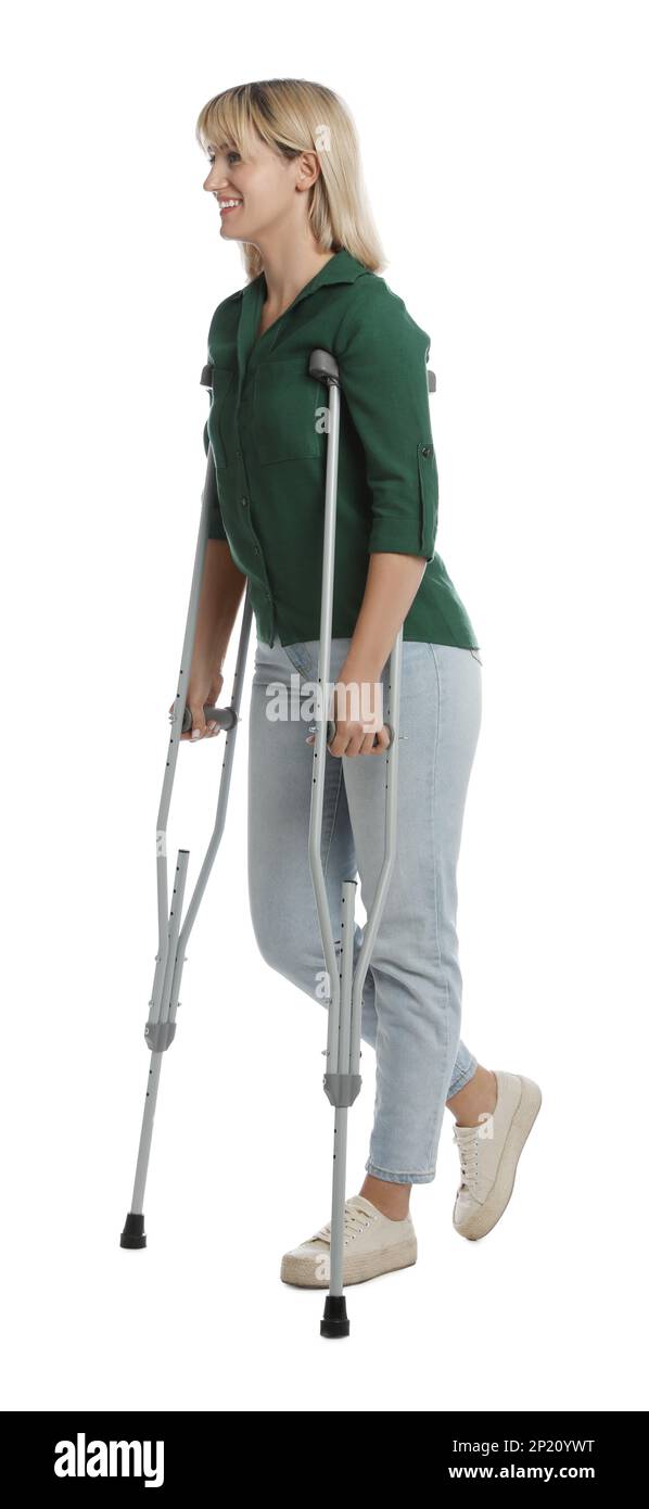 Full length portrait of woman with crutches on white background Stock