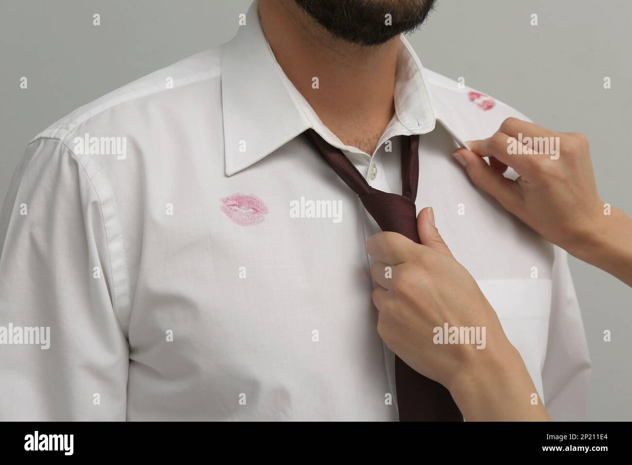 Woman noticed lipstick kiss marks while straightening her husband's