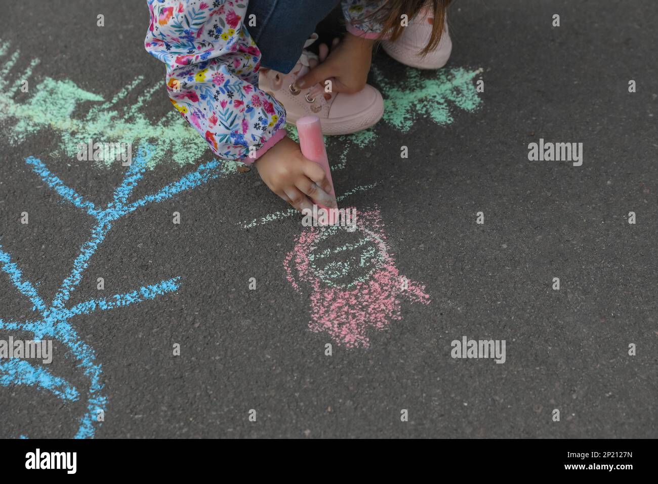 Child drawing family with chalk on asphalt, closeup Stock Photo - Alamy
