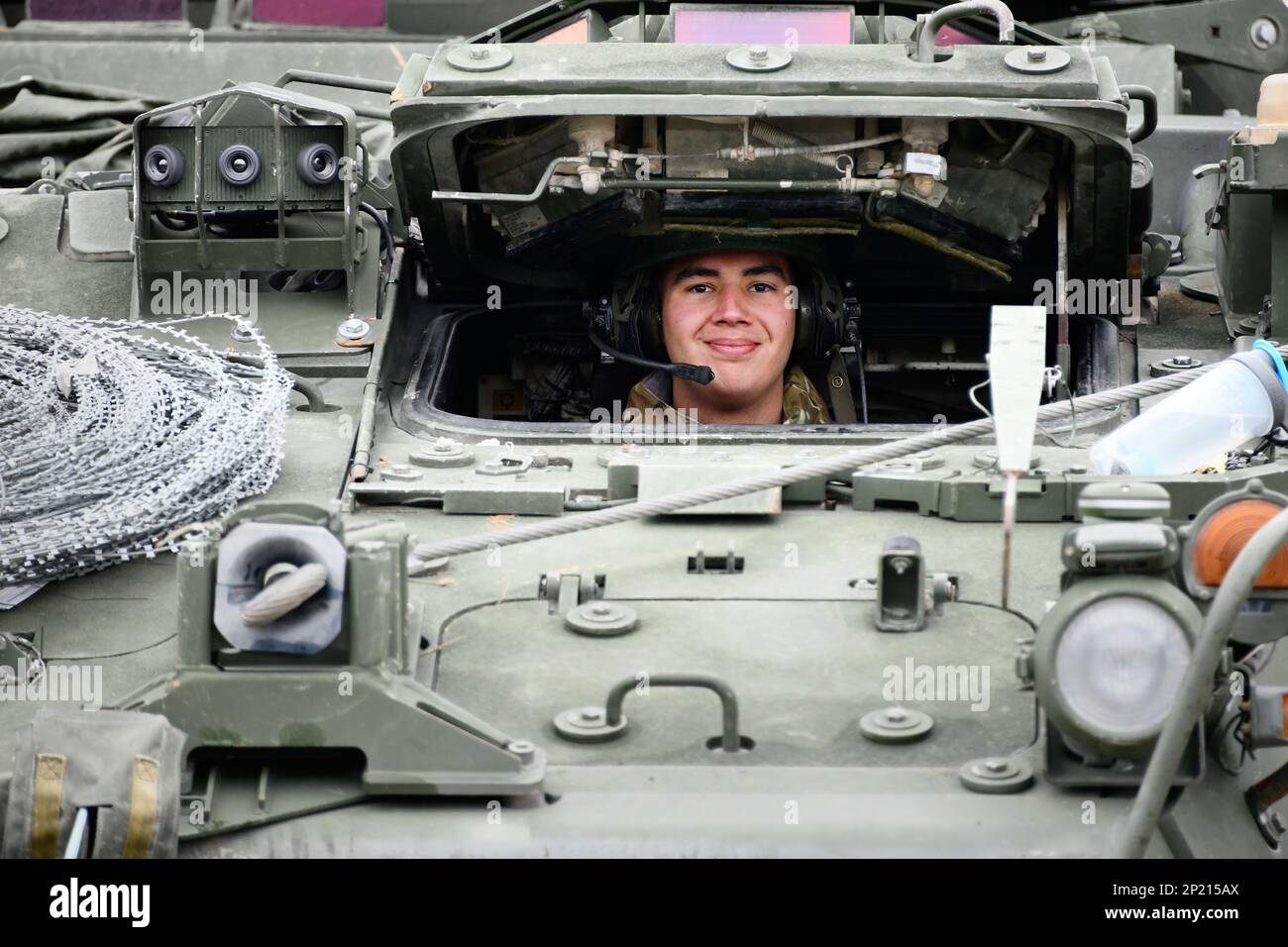 U.S. Army Spc. Diego Villagomes with Palehorse Troop, 4th Squadron, 2nd Cavalry Regiment smiles for a photo as he gets ready to move a Stryker Fighting Vehicle for a training exercise on Rose Barracks, Vilseck, Germany, Jan. 10, 2023. 2CR provides V Corps with a lethal and agile force capable of rapid deployment throughout the European theater in order to assure allies, deter adversaries, and when ordered, defend the NATO alliance. Stock Photo