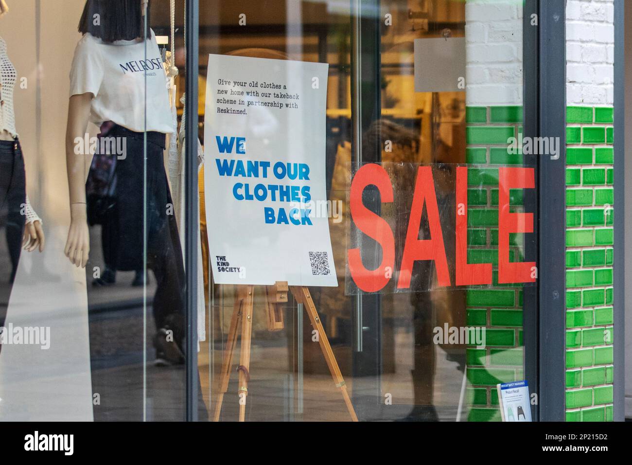 'We want our clothes back' Reskinned Recycling, Give unwanted clothes a new home by re-selling. Repurposing of old Clothes sign in River Island Fashion Store Sale in Fishergate, Preston Stock Photo