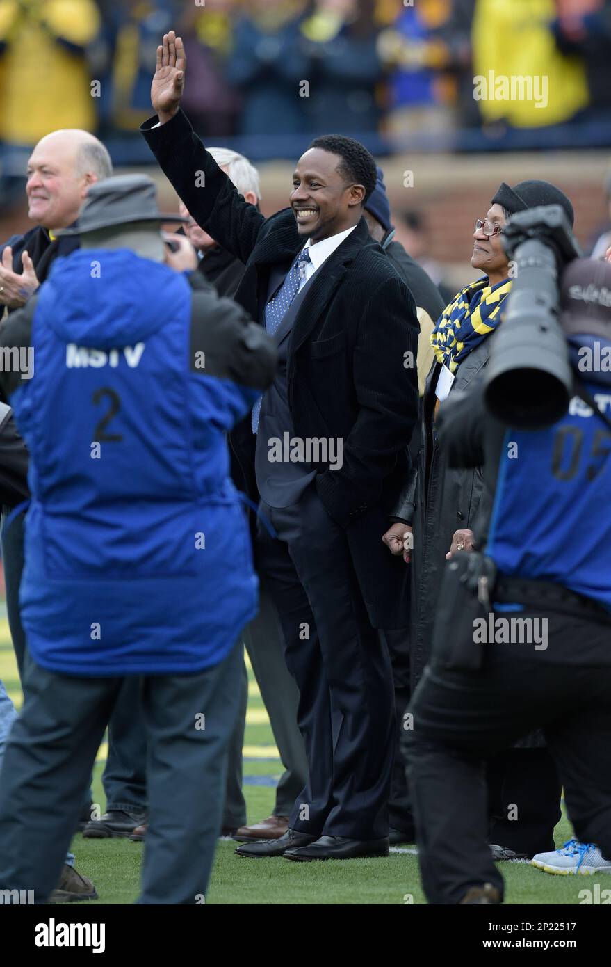 28 November 2015: Former Michigan great, Desmond Howard waves to the fans  after having his jersey #21 retired during a special ceremony at Saturday's  Michigan game against Ohio State at Michigan Stadium.