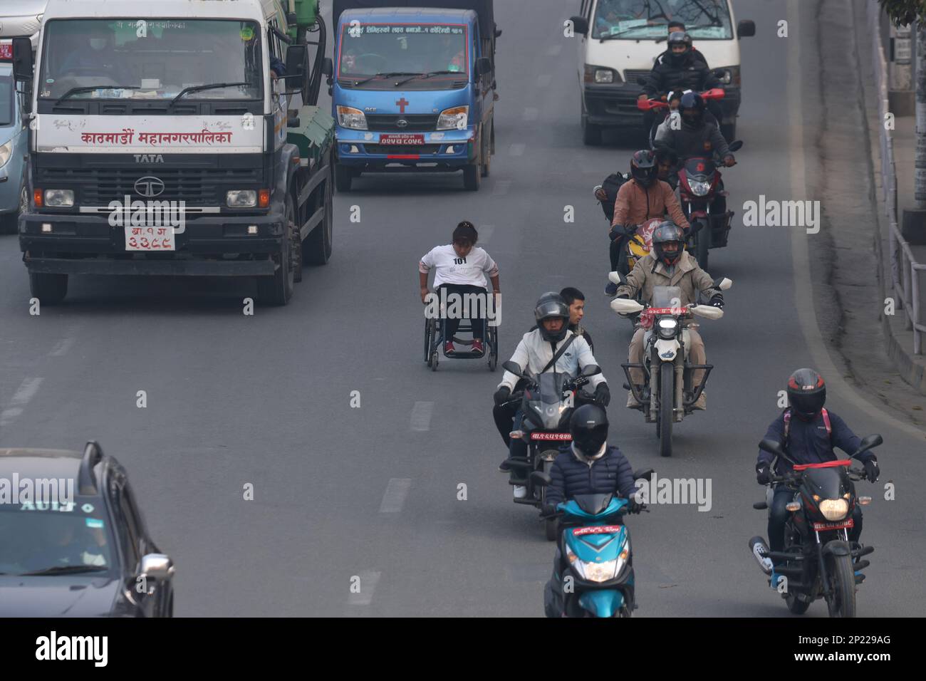 Kathmandu, NE, Nepal. 4th Mar, 2023. A woman runs on her wheelchair on a busy road during a wheelchair marathon on the occasion of International Wheelchair Day in Kathmandu, Nepal on March 4, 2023. (Credit Image: © Aryan Dhimal/ZUMA Press Wire) EDITORIAL USAGE ONLY! Not for Commercial USAGE! Stock Photo