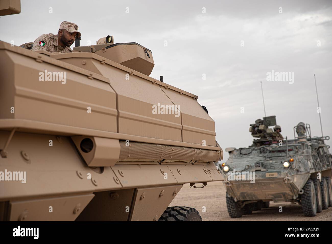 (Left) A Kuwait Land Forces vehicle commander for a Kuwaiti M1135