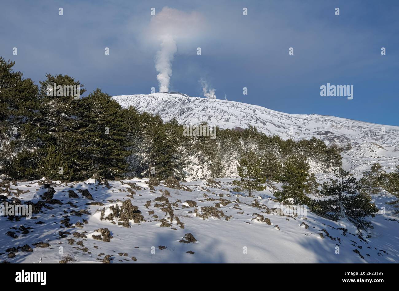 covered in snow Mount Etna volcano eruption from summit craters in