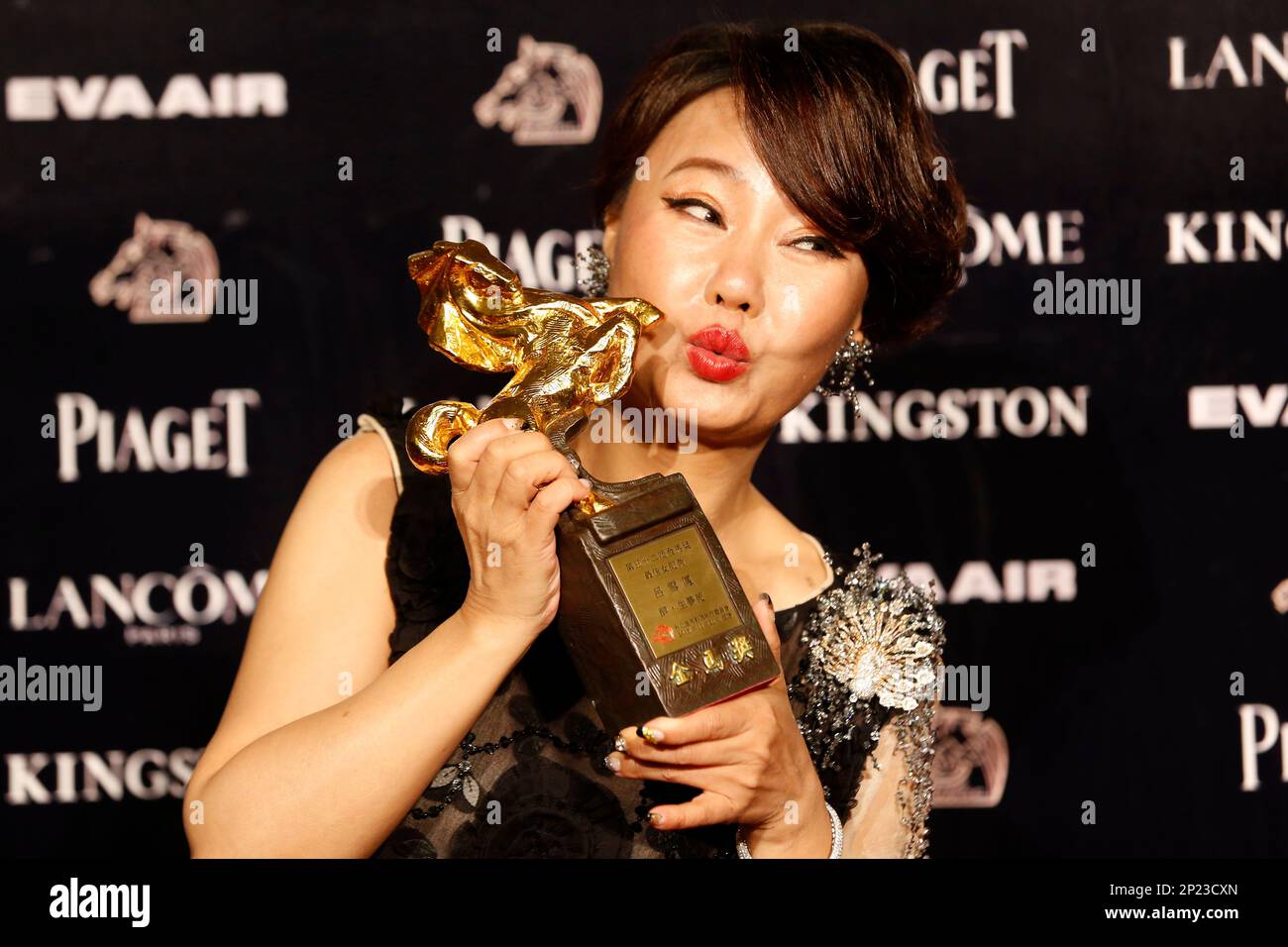 Taiwanese actress Lu Xuefeng poses with her award for Best Supporting ...