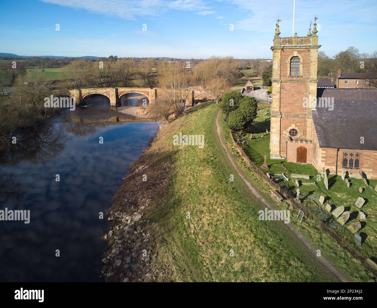 old bridge over the River Dee and church in Bangor-is-y-Coed in Wales Stock Photo