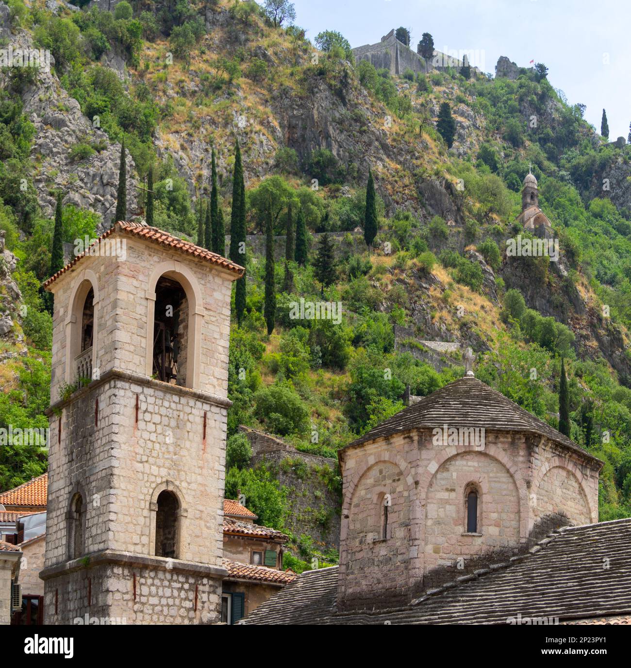 Church of St. Mary Collegiate dome and bell tower bellow the Church of Our Lady of Remedy up in the mountain above Kotor Stock Photo