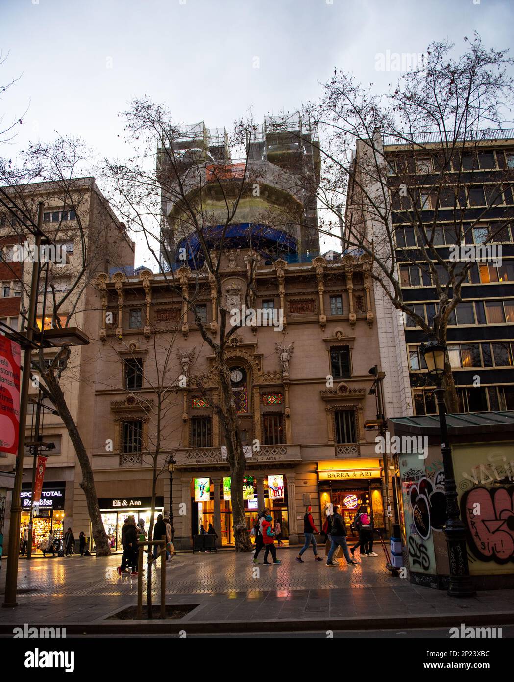 Barcelona,Spain-February 21,2023 People walk in las ramblas early in the evening. Stock Photo