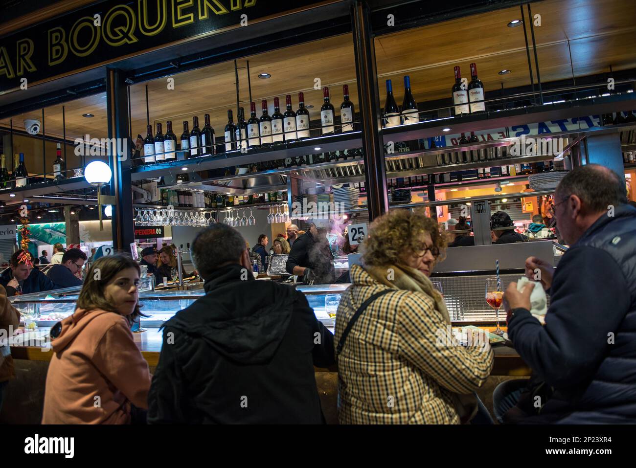 Barcelona,Spain-February 21,2023 People sit in a tapas bar in the evening Stock Photo